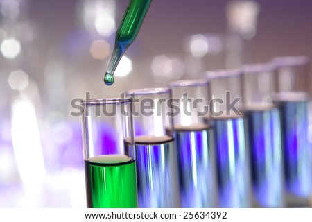 Laboratory pipette with drop of green liquid over test tubes filled with blue chemical solution for an experiment in a science research lab