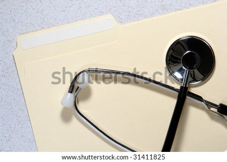File folder with blank copy space label for text and medical doctor pulse monitoring stethoscope