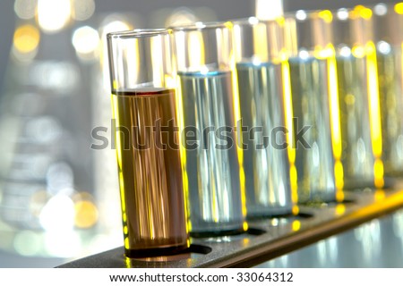 Laboratory glass test tubes filled with liquid chemical on a rack for an experiment in a science research lab