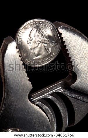 Pliers squeezing tight and deforming a quarter Dollar coin