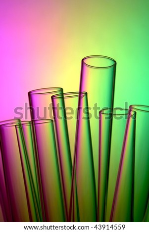 Laboratory glass test tubes over yellow with pink and green psychedelic background for a groovy experiment in a science research lab
