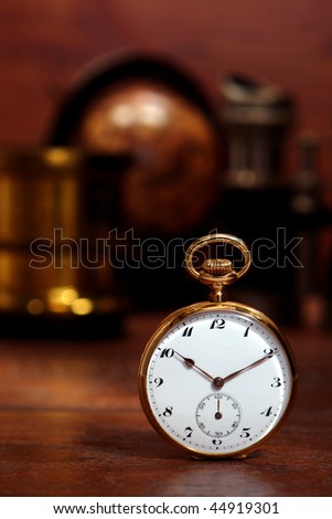Antique gold pocket watch on a desk in an old curio and memorabilia shop