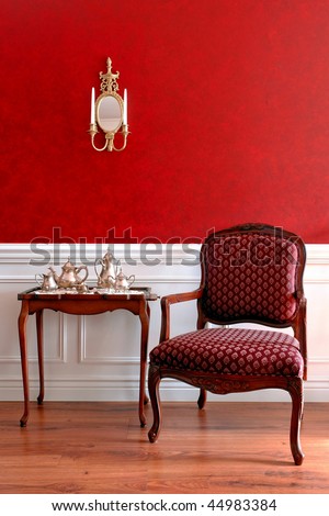 Colonial American style historic house interior with old tea tray table and antique chair