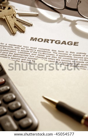 Real estate mortgage loan contract document with keys and calculator on lender desk in financial lending broker agent office (fictitious document with authentic legal language)