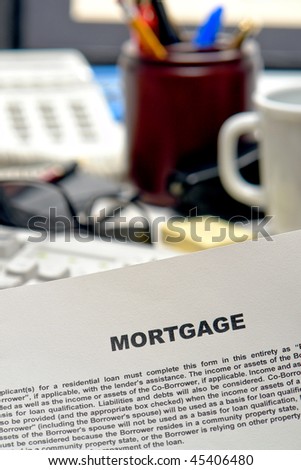 Real estate mortgage bank loan contract document on busy lender desk in lending agent broker office (fictitious document with authentic legal language)
