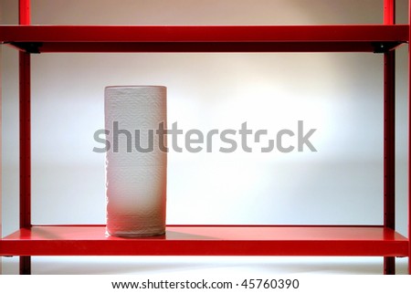 Household roll of generic paper towel on a red steel shelf in a house storage room