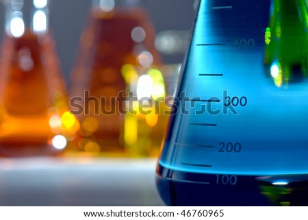 Laboratory glass conical Erlenmeyer flask filled with blue liquid for an experiment in a science research lab