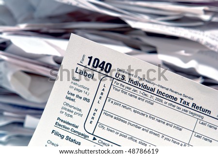 American IRS Internal Revenue Service individual income tax form 1040 at filing time with pile of receipts