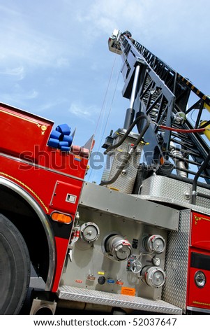 Tall ladder deployed on an emergency fire engine truck