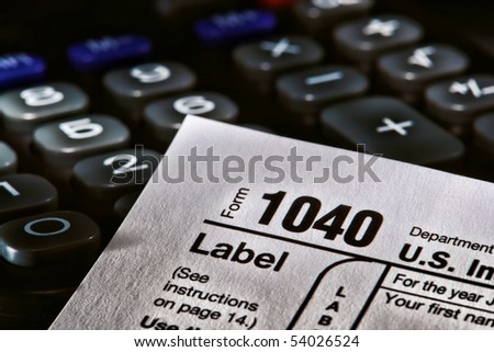 American IRS Internal Revenue Service income tax form 1040 over a calculator