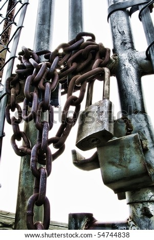 Chain and heavy duty commercial padlock on an industrial steel gate