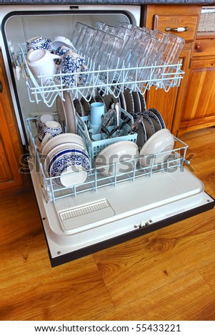 Dishwasher full and loaded with clean dishes after a wash cycle in a modern kitchen