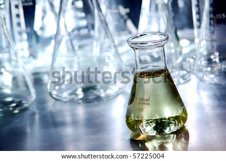 Laboratory glass conical Erlenmeyer flask filled with liquid and laboratory glassware for an experiment in a science research lab