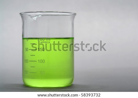 Laboratory scientific beaker filled with green liquid for an experiment in a science research lab