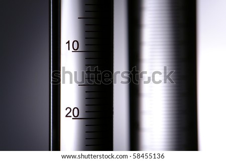 Laboratory glass scientific graduated cylinder filled with clear transparent liquid for an experiment in a science research lab