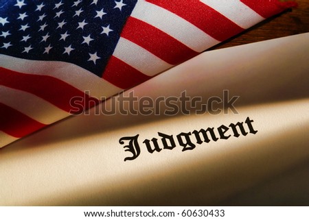 Judicial judgment decree with small American flag on a court judge desk