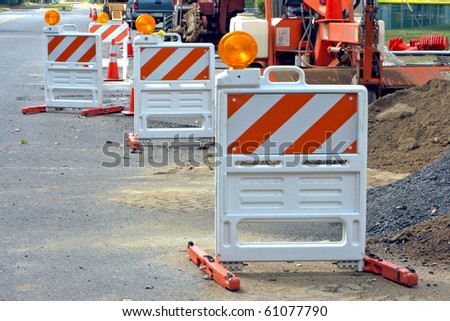 Reflective safety traffic barriers at road highway construction site for a temporary detour during street work improvement