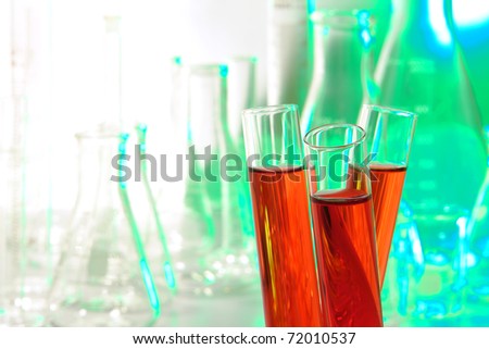 Three research laboratory glass test tubes filled with red liquid in a lab science experiment