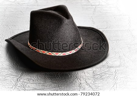 American West Stetson style traditional western black felt cowboy hat on leather surface