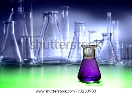 Scientific laboratory glass conical Erlenmeyer flask filled with purple chemical liquid for a chemistry experiment in a science research lab