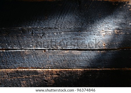 Old and distressed antique charcoal smoked burned board made of barn wood plank with rough weathered textured grain grunge background