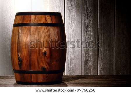 Old wood antique whisky wood barrel or wine keg container in a nostalgic American vintage wooden warehouse