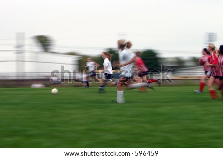 Girls soccer game with a long shutter to show motion of the game.