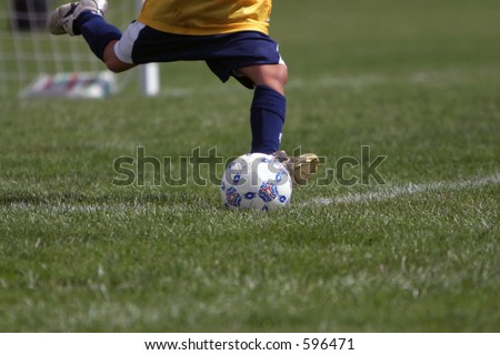 Closeup of a girls soccer goalie kicking the ball