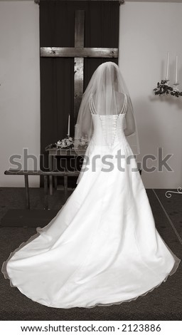 stock photo : Bride at the Alter in front of a large Cross. Photo is