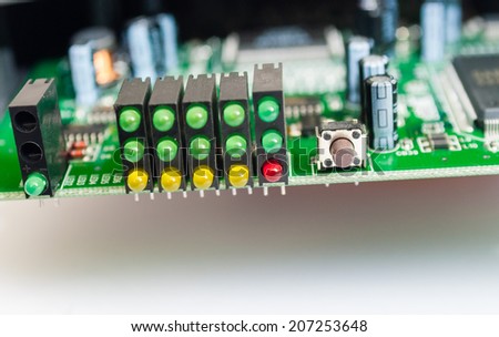 Close-up of LED lights on circuit board on white background.