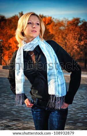 Outdoors portrait of colorful clothed gorgeous fall fashion girl.