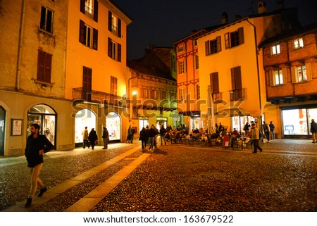 COMO, ITALY - NOVEMBER 16: People walking in the old town of Como city at the evening on November 16, 2013 in Como, Italy.
