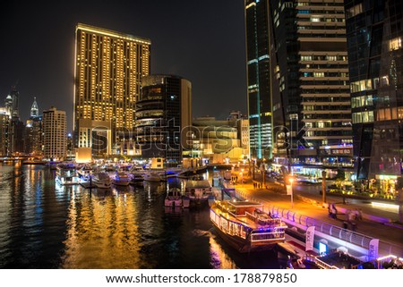 DUBAI, UAE - FEBRUARY 10, 2014: Dubai downtown night scene with city lights, luxury new high tech town in middle East. Dubai Marina cityscape.