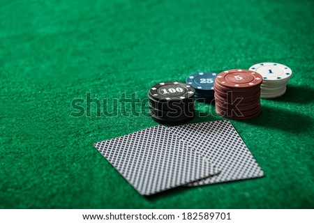 aces and chips on a green felt
