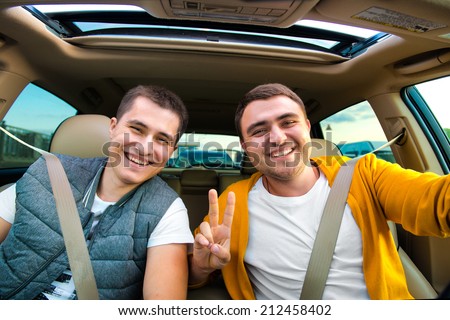 Happy friends ready for vacations driving car
