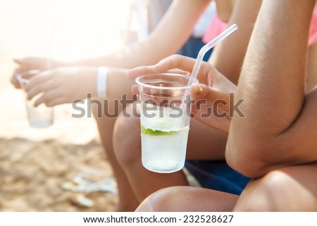 Group of people drinking cocktails on the beach