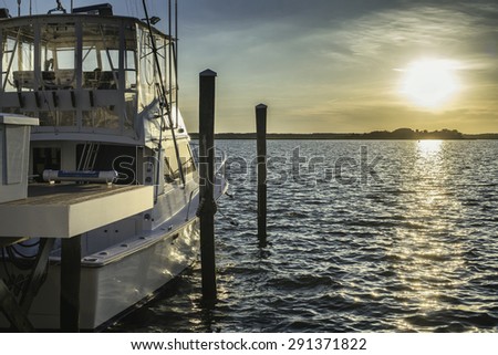Fishing boat yacht ready to go in the ocean from a dock at sunset time