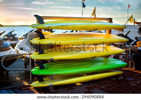 Colorful kayaks near the lake. Water sport equipment rent.