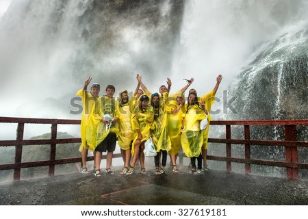 NIAGARA FALLS, NY - JULY 13: Happy Visitors on Niagara Falls on July 13, 2015 in Niagara Falls, New York. Niagara Falls is the waterfalls with the highest flow rate in the world.