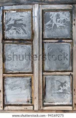Window of country log house in village on winter