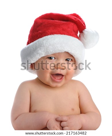 Adorable baby boy wears a Santa hat for his first Christmas, isolated on white.