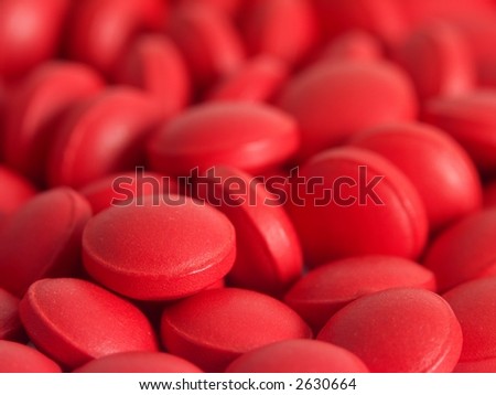 Pile of many small red pills.
