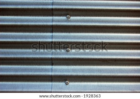 Sheet metal siding with screws.