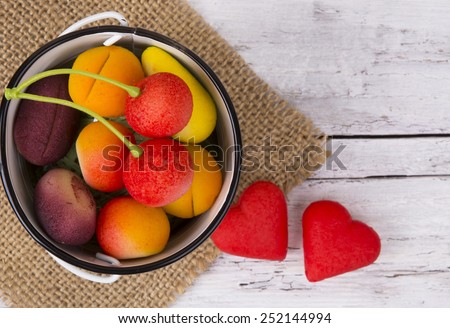 Bright Fruit shaped candies in macro image of marzipan sweets on the wooden table