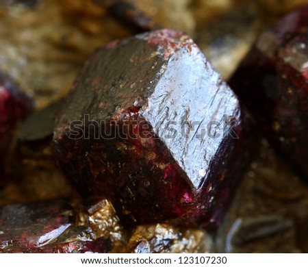 Crystal of a dark red precious mineral of Grenades