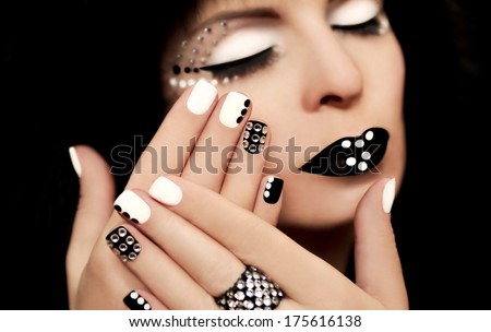 Makeup And Manicure With Rhinestones On A Beautiful Young Girl On A Black Background