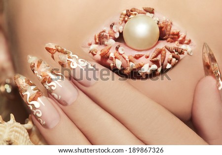 Design with these sea shells inside nails and lips with a pearl on a woman\'s face.