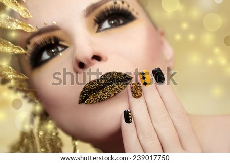 Caviar manicure in yellow black nails with black and gold sequins and beads colored lips.