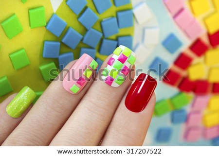 Colorful manicure design of square metal decorations on the nails neon colors.