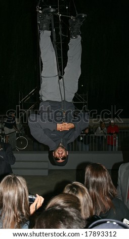 NEW YORK, NY -- SEPTEMBER 22, 2008: David Blaine greets fans while hanging upside down in Central Park during his \